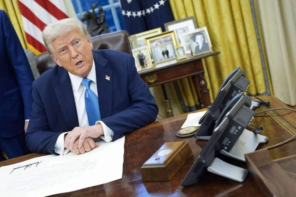 12789968 US President Trump signs executive order in the Oval Office